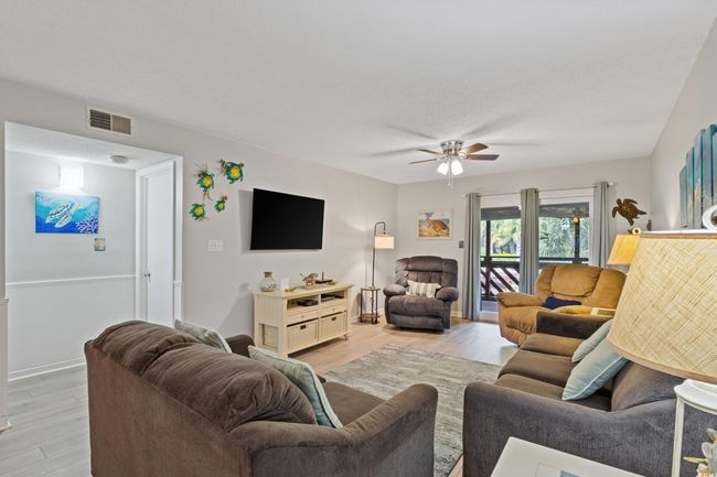 Living area featuring baseboards, ceiling fan, light wood-style flooring, and visible vents | Image 15