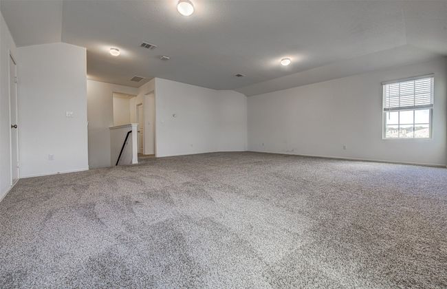 Spare room with carpet floors, baseboards, and vaulted ceiling | Image 19