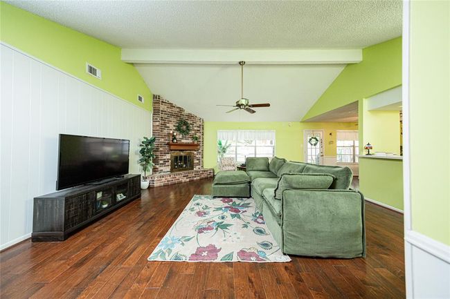 Inside you are greeted by beautiful wood floors throughout the home. | Image 4