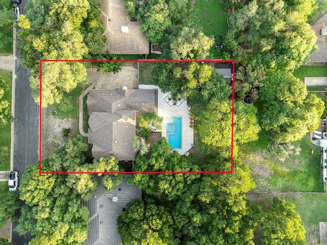 Aerial view of property and surrounding area with a pool and property parcel outlined | Image 39