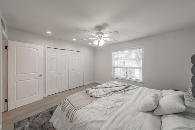 Bedroom with baseboards, recessed lighting, wood finished floors, a closet, and ceiling fan | Image 15