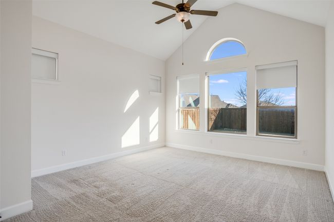 Unfurnished room featuring a ceiling fan, carpet, and high vaulted ceiling | Image 18