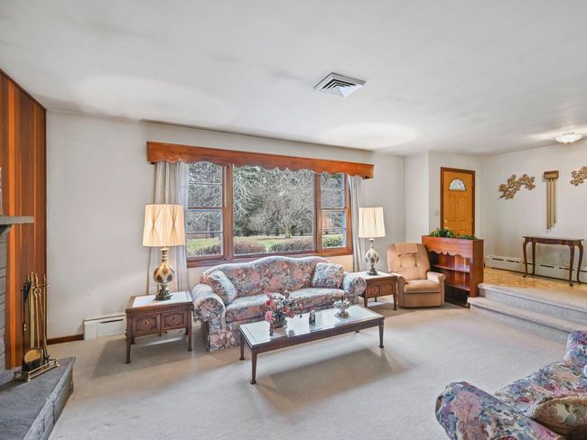 Living room featuring carpet floors and a baseboard radiator | Image 6