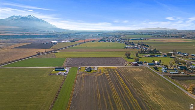 View of rural area with a mountain backdrop and large plots for crops | Image 44