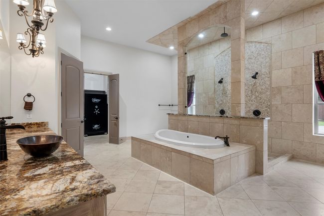 Full bath with tile patterned flooring, recessed lighting, a walk in shower, and a bath. | Image 17