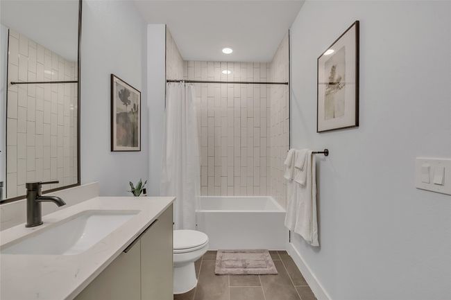 Full bathroom with vanity, tile patterned floors, and shower / tub combo with curtain | Image 22