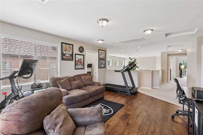 Living area with dark wood-style flooring and baseboards | Image 16