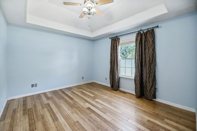The owner's suite is a luxurious retreat, boasting a sophisticated trey ceiling with updated ceiling fan and elegant bamboo flooring! 2095 Bolden Drive, Murfreesboro, TN 37127 | Image 15