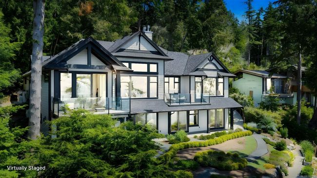 Back of house with a shingled roof, a chimney, and view of scattered trees | Image 96