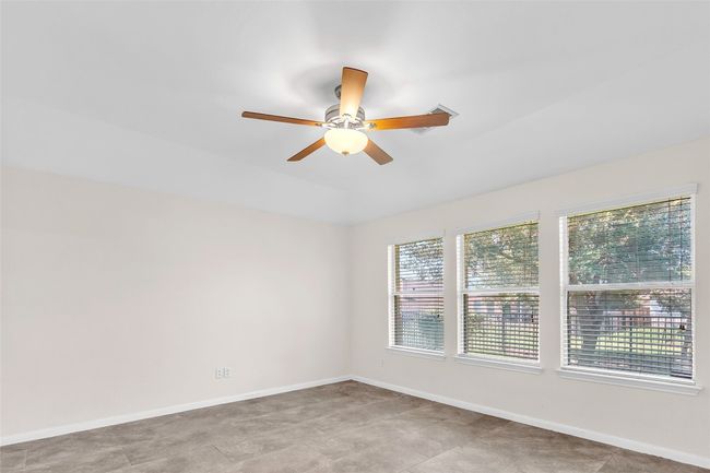 Spare room with baseboards and ceiling fan | Image 14