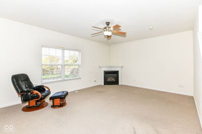 Great room with gas fireplace, ceiling fan with light has plenty of sunlight pouring in! | Image 3