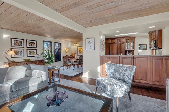 Living room featuring beam ceiling, wood ceiling, and dark hardwood / wood-style flooring | Image 8