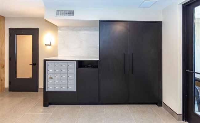 The lobby area has tenant mailboxes, convenient garbage, and package delivery area. | Image 5