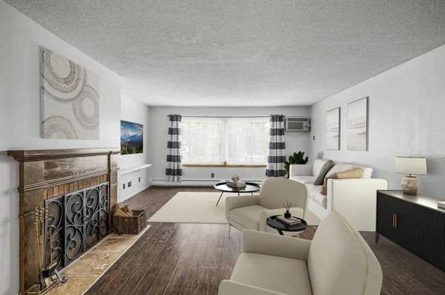 The living area is centered around a charming fireplace for a cozy and inviting ambiance. | Image 6