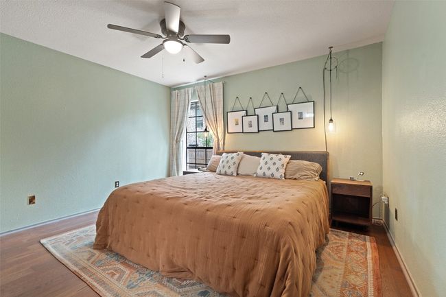 Bedroom featuring baseboards, a ceiling fan, and wood finished floors | Image 28
