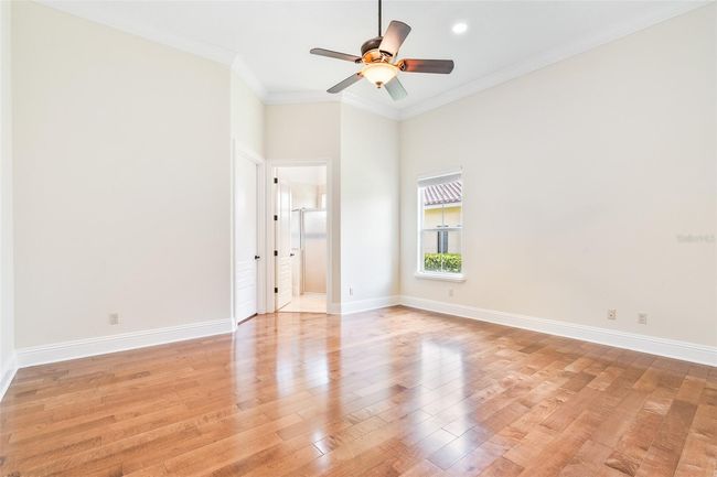 This light-filled bedroom offers beautiful hardwood floors, crown molding, and a private ensuite bath—perfect for comfort, privacy, and flexibility. | Image 19