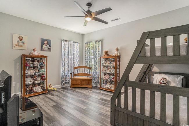 Bedroom with wood finished floors, baseboards, and a ceiling fan | Image 18
