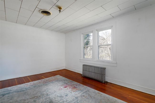 Spare room with radiator and dark wood-type flooring | Image 11