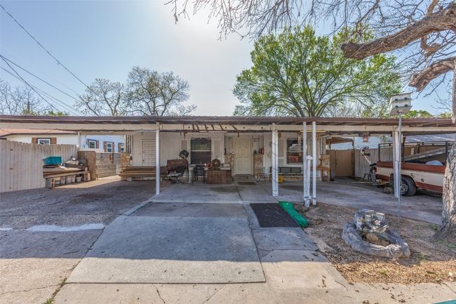 Back of property with an attached carport, fence, and concrete driveway | Image 6
