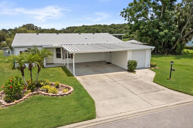 Beautiful landscaped Yard with Sprinkler System.Grass cut, edge & blow maintained by the Community.NEWER ROOF | Image 26
