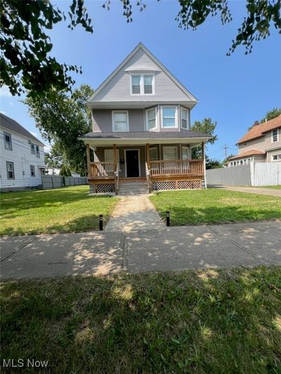 View of front facade featuring a lawn and a porch | Image 1