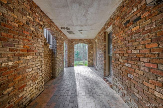Under the front porch is a patio where the outside entrance for the level 1 apartment is located. Also it is a great place for resting and listening to nature and the sound of Harrogate Springs Creek | Image 63