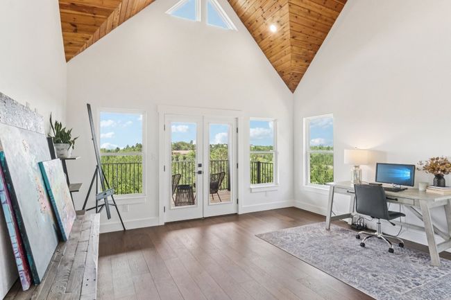 Office space with high vaulted ceiling, french doors, wood ceiling, and wood-type flooring | Image 28