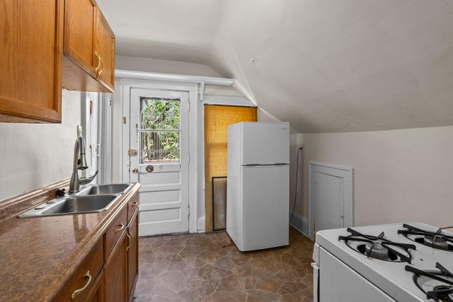 Upstairs, discover the 3rd unit with its own private entrance, making it ideal as a separate apartment or short-term rental. | Image 16