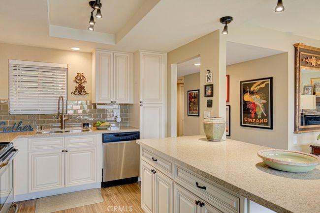 Another view of the kitchen. Note the large countertop area on the island. | Image 17
