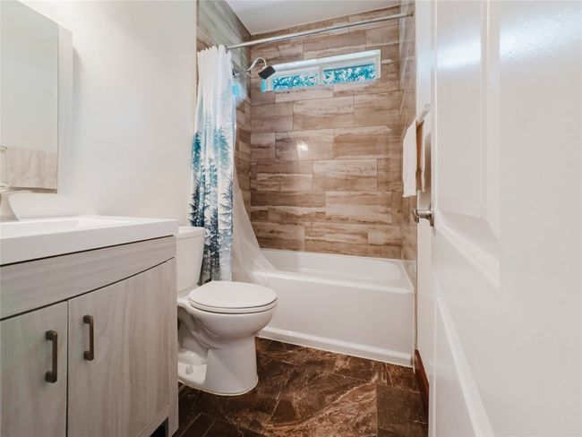 Bathroom with vanity and shower / bathtub combination with curtain | Image 32