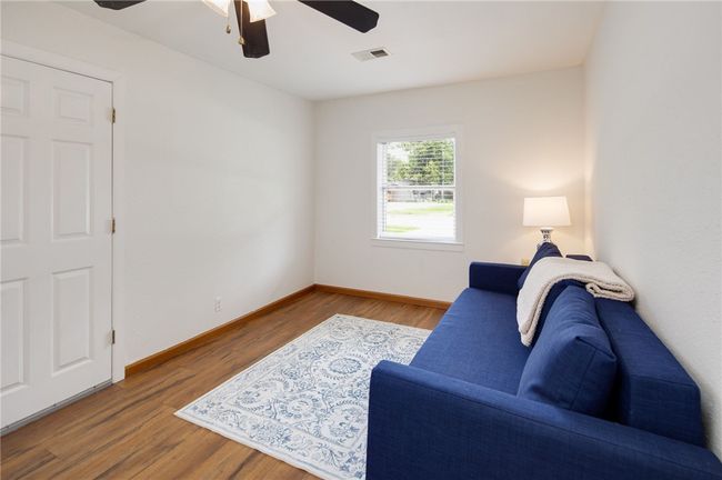 Living room featuring ceiling fan, baseboards, and wood finished floors | Image 12