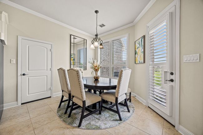 Dining space featuring light tile patterned floors, ornamental molding, and baseboards | Image 18