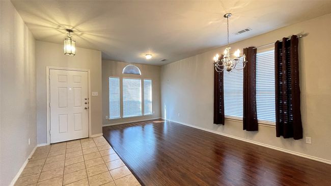 Entryway featuring a chandelier, healthy amount of natural light, and light tile patterned floors | Image 4