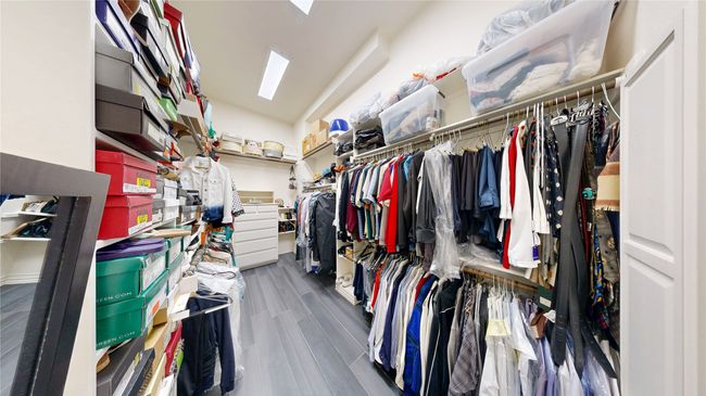 Primary Walk-in closet with built-in ironing board & chest of drawers | Image 25