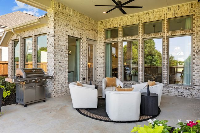 View of patio with a ceiling fan, area for grilling, and an outdoor living space | Image 36