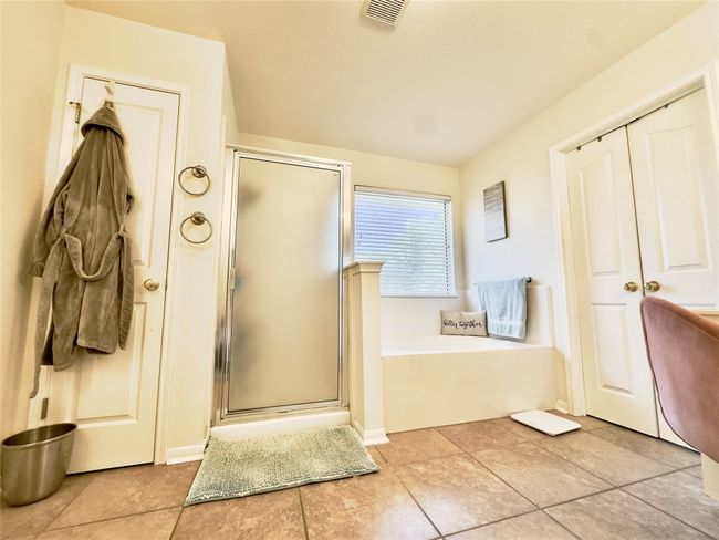 Full bathroom featuring a shower stall and a bath | Image 33