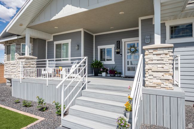 View of exterior entry with a porch and stone siding | Image 8