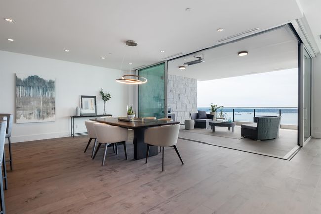 Dining area featuring floor to ceiling windows, wood finished floors, and recessed lighting | Image 12