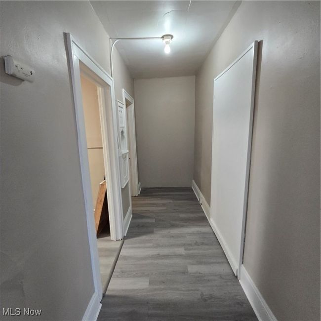 Hallway with wood finished floors and baseboards | Image 8