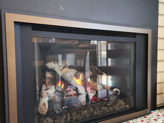 Interior details featuring a glass covered fireplace | Image 13