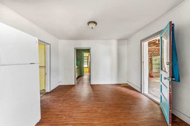 Unfurnished room featuring wood finished floors, healthy amount of natural light, and ornamental molding | Image 7