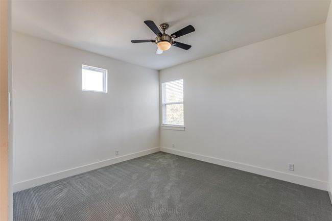 Spare room featuring baseboards, dark colored carpet, and a wealth of natural light | Image 27