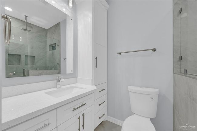 Bathroom featuring toilet, a shower stall, and vanity | Image 16
