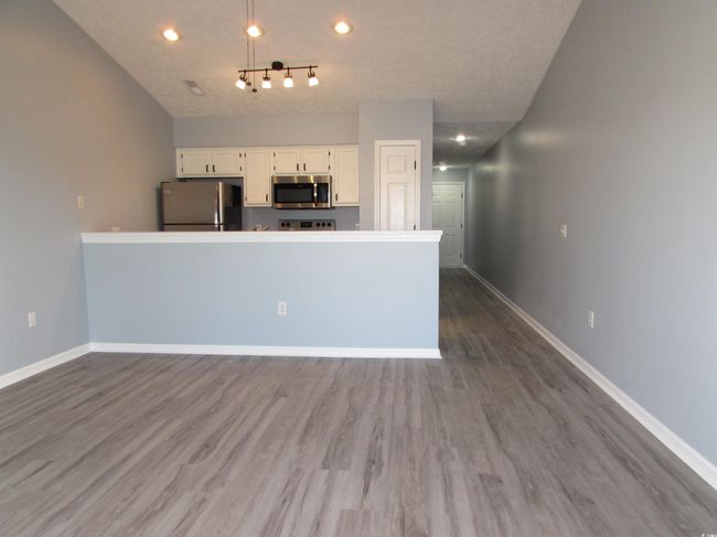 View from living room towards the kitchen. | Image 33