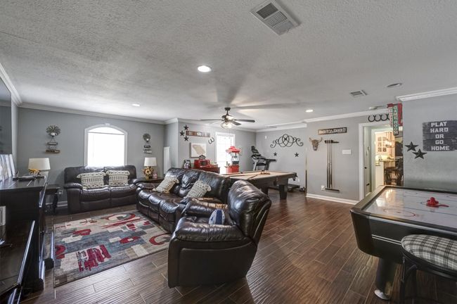 Living area featuring pool table, visible vents, wood finish floors, and ceiling fan | Image 27