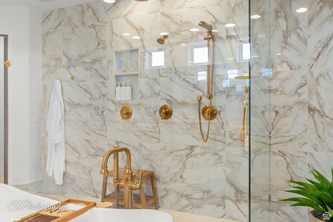 Full bath featuring a soaking tub and a marble finish shower | Image 30