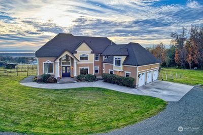 The home sits majestically atop a hill on a private drive with views of the Puget Sound, Islands and the snowcapped Olympic Mts | Image 1