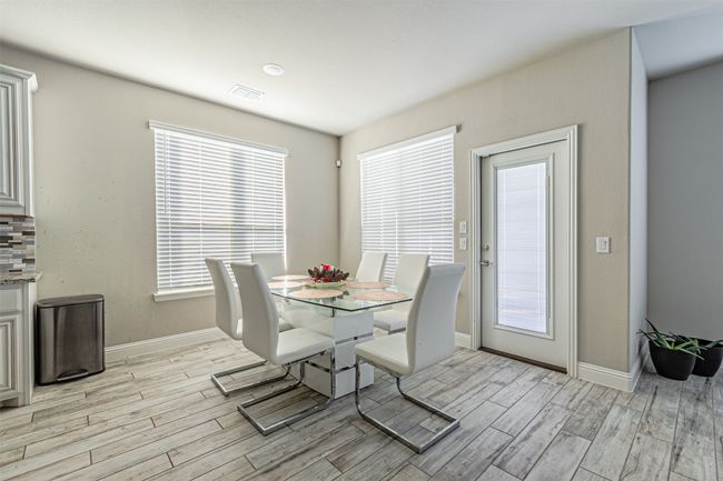Dining room featuring light wood-type flooring, baseboards, and healthy amount of natural light | Image 23