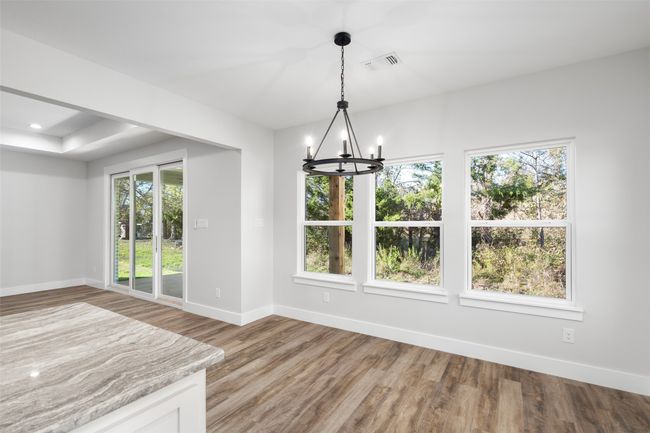 Unfurnished dining area featuring hardwood / wood-style floors and a chandelier | Image 17