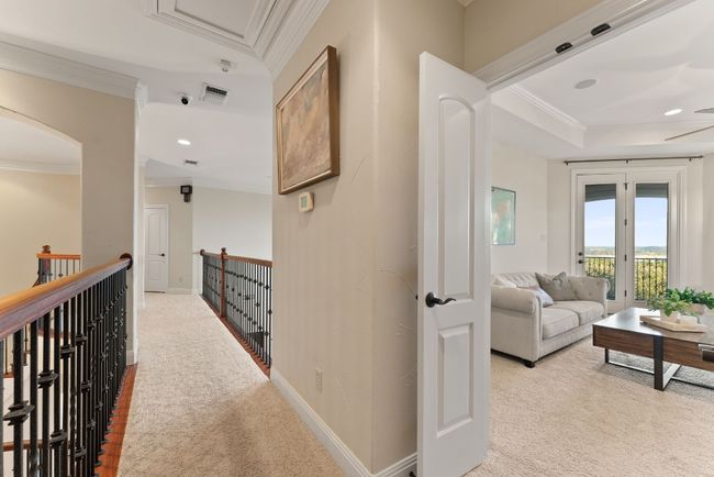 Upstairs hallway with view of the family room. | Image 19